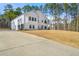 White modern farmhouse with attached garage and expansive lawn at 130 Wesley Pl, Fayetteville, GA 30214