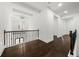 Upstairs hallway with dark hardwood floors and iron railings at 130 Wesley Pl, Fayetteville, GA 30214