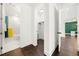 Bright hallway with dark hardwood floors, linen closet and bathroom at 130 Wesley Place, Fayetteville, GA 30214