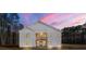 Stunning modern farmhouse exterior at dusk at 130 Wesley Pl, Fayetteville, GA 30214