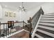 Modern staircase with dark wood and metal railing at 130 Wesley Place, Fayetteville, GA 30214