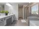 Bathroom featuring double vanity, glass shower enclosure and tile surround at 1553 Brunswick St, Lithia Springs, GA 30122