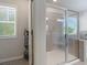 A view of a bathroom featuring a glass enclosed shower with a tiled bench at 1553 Brunswick St, Lithia Springs, GA 30122