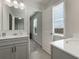 Well-lit bathroom featuring dual sinks, a large mirror, and a window at 1553 Brunswick St, Lithia Springs, GA 30122