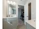 Bright bathroom featuring dual sinks, a vanity, and an adjacent doorway at 1553 Brunswick St, Lithia Springs, GA 30122