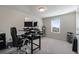 Spacious bedroom with neutral tones, featuring an office setup and carpet floors at 1553 Brunswick St, Lithia Springs, GA 30122