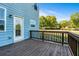 View from the deck showcasing the wood flooring, railings, and backyard with trees at 1553 Brunswick St, Lithia Springs, GA 30122