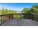 View from the deck showcasing the wood flooring, dark railings, and backyard trees at 1553 Brunswick St, Lithia Springs, GA 30122