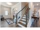 Welcoming foyer with hardwood floors, a staircase, and views of the dining area at 1553 Brunswick St, Lithia Springs, GA 30122