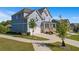 Side view of a two-story light blue house with a white garage door and landscaping at 1553 Brunswick St, Lithia Springs, GA 30122