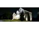 Exterior of the home showcasing the two-car garage, front porch, and landscaped front yard at night at 1553 Brunswick St, Lithia Springs, GA 30122