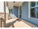 Covered front porch with brick columns and a light blue exterior at 1553 Brunswick St, Lithia Springs, GA 30122