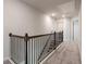 Upstairs hallway with dark wood railing and carpet at 1553 Brunswick St, Lithia Springs, GA 30122