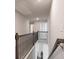 Hallway with dark wood railing overlooking stairs and a living area at 1553 Brunswick St, Lithia Springs, GA 30122