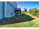 Back of house with deck and sloped lawn at 1553 Brunswick St, Lithia Springs, GA 30122