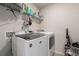 Functional laundry room with modern washer and dryer, plus convenient shelving at 1553 Brunswick St, Lithia Springs, GA 30122