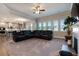 Open-concept living room with fireplace, large windows, and view of the modern kitchen at 1553 Brunswick St, Lithia Springs, GA 30122