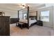 Elegant primary bedroom features a four-poster bed and tray ceiling at 1553 Brunswick St, Lithia Springs, GA 30122