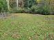 Wooded backyard with a spacious grassy area at 300 E Campbellton E St, Fairburn, GA 30213