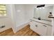 Updated bathroom with white tile and granite vanity at 300 E Campbellton E St, Fairburn, GA 30213