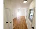 Light and airy hallway with wood-look floors and doors at 300 E Campbellton E St, Fairburn, GA 30213