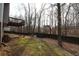 Wooded backyard with a deck and wooden fence at 355 Holland Springs Way, Powder Springs, GA 30127