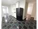 Basement kitchenette with black refrigerator and dark tile flooring at 355 Holland Springs Way, Powder Springs, GA 30127