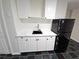 Basement kitchenette with white cabinets and quartz countertops at 355 Holland Springs Way, Powder Springs, GA 30127