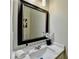 Modern bathroom with dual sinks, granite countertop, and a large framed mirror at 355 Holland Springs Way, Powder Springs, GA 30127