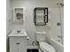 A well-lit bathroom features a combined shower and tub with black accented shelf at 355 Holland Springs Way, Powder Springs, GA 30127