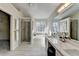 Bright bathroom featuring a soaking tub, glass shower, double sink vanity, and a walk-in closet at 355 Holland Springs Way, Powder Springs, GA 30127