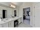 Bathroom featuring a large mirror and an open doorway to the main bedroom at 355 Holland Springs Way, Powder Springs, GA 30127