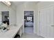 Bathroom with a large vanity, open doorway to the main bedroom, and a door to the hallway at 355 Holland Springs Way, Powder Springs, GA 30127