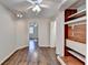 Hardwood floors adorn a bedroom, showcasing built-in shelving and a ceiling fan at 355 Holland Springs Way, Powder Springs, GA 30127