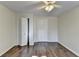 A bedroom with wood-look floors features an overhead fan and multiple doors at 355 Holland Springs Way, Powder Springs, GA 30127