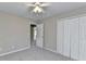 Bright bedroom featuring carpeted floors, neutral walls and a ceiling fan at 355 Holland Springs Way, Powder Springs, GA 30127