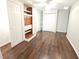 Finished basement bedroom with dark brown vinyl plank flooring and built-in shelving at 355 Holland Springs Way, Powder Springs, GA 30127