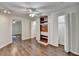 A bedroom with hardwood floors features multiple closets and a ceiling fan at 355 Holland Springs Way, Powder Springs, GA 30127