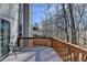 Spacious outdoor deck offers a cozy seating area and peaceful backyard views at 355 Holland Springs Way, Powder Springs, GA 30127