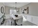 Elegant dining room featuring hardwood floors, wainscoting, and modern chandelier at 355 Holland Springs Way, Powder Springs, GA 30127