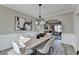 Bright dining room with decorative artwork, wood table, and arched doorway to living room at 355 Holland Springs Way, Powder Springs, GA 30127