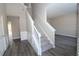 Bright entryway with gray carpet stairs and gray vinyl plank flooring at 355 Holland Springs Way, Powder Springs, GA 30127