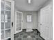 Inviting entryway featuring tiled flooring, a glass door, and ample closet space at 355 Holland Springs Way, Powder Springs, GA 30127