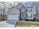 Charming two-story home with stone accents, attached two-car garage and professionally landscaped yard at 355 Holland Springs Way, Powder Springs, GA 30127