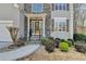 Welcoming front entrance with stone accents, professionally landscaped yard, and well-maintained walkway at 355 Holland Springs Way, Powder Springs, GA 30127