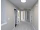 Long hallway with multiple doors leading to bedrooms and a bathroom at 355 Holland Springs Way, Powder Springs, GA 30127