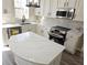 Modern kitchen with white cabinets, quartz countertops and island at 355 Holland Springs Way, Powder Springs, GA 30127