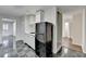 Kitchenette with ample counter space, black refrigerator, and black and gray tile flooring at 355 Holland Springs Way, Powder Springs, GA 30127