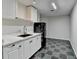 Bright kitchenette with ample counter space, a modern refrigerator, and black and gray tile flooring at 355 Holland Springs Way, Powder Springs, GA 30127