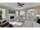 Open concept living room showing decorative fireplace and flow into bright eat-in kitchen at 355 Holland Springs Way, Powder Springs, GA 30127